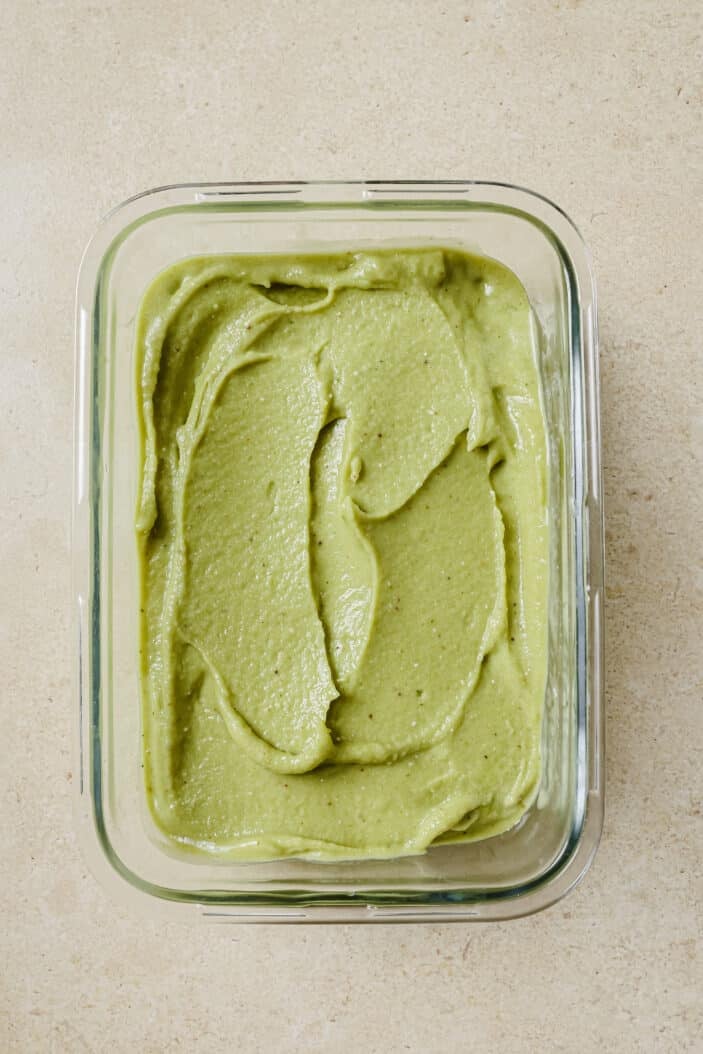 matcha nice cream that's been smoothed out into a glass container