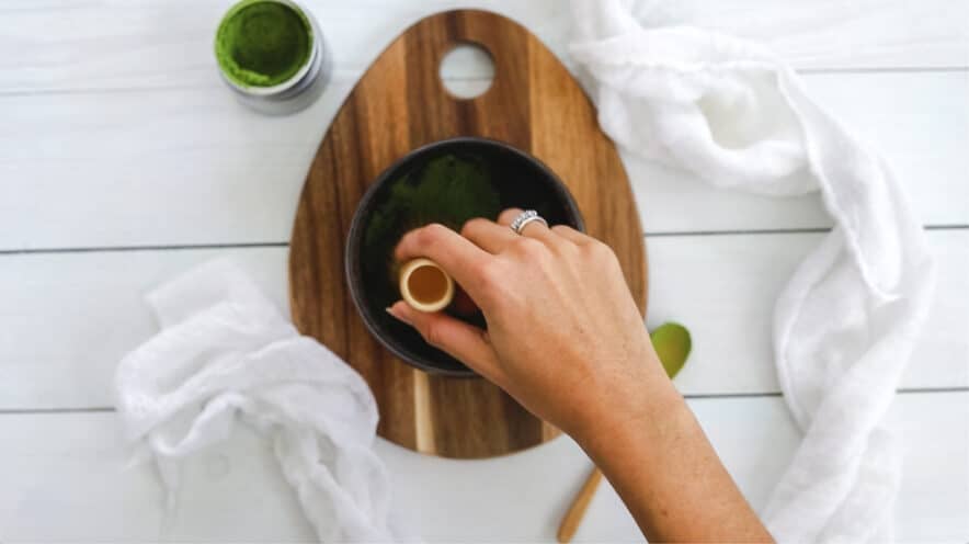 whisking the matcha in the flat bottom bowl to break any clumps