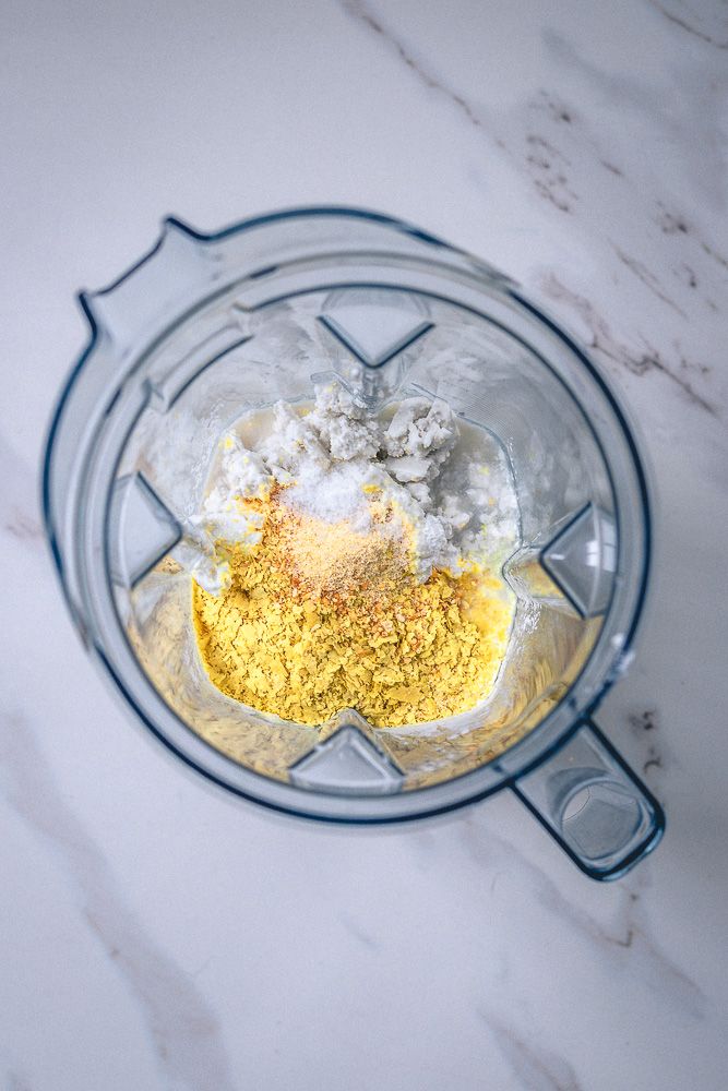 nutritional yeast, coconut milk, onion powder, garlic powder and salt in a blending container.
