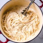 ultra creamy cashew vegan alfredo in a large red pot.