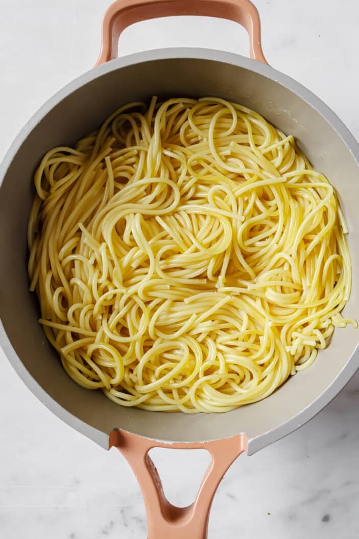 cooked spaghetti noodles in a skillet