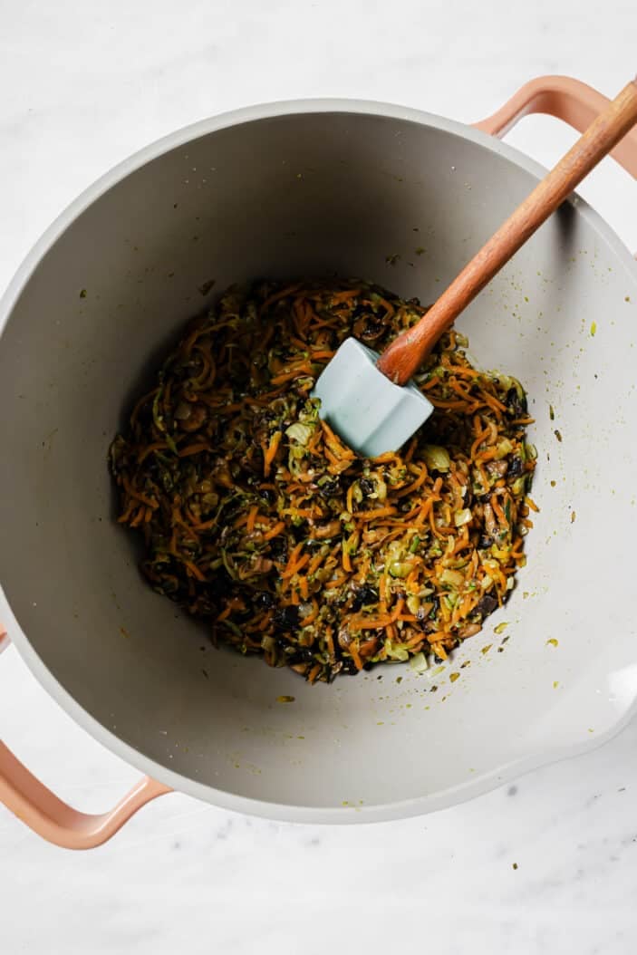 mushrooms, carrot and zucchini cooking in a saucepan until soft