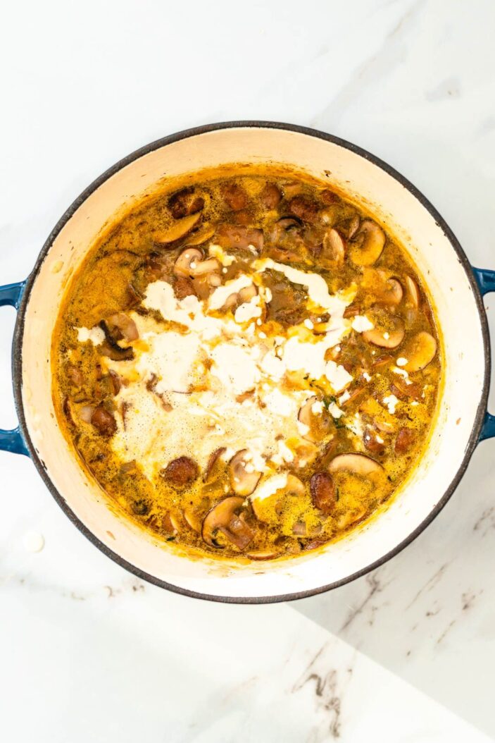 Toss in the thyme and bay leaf and pour in the remaining broth. Simmer the soup for 10 minutes, or until the mushrooms are perfectly soft and cooked through. 