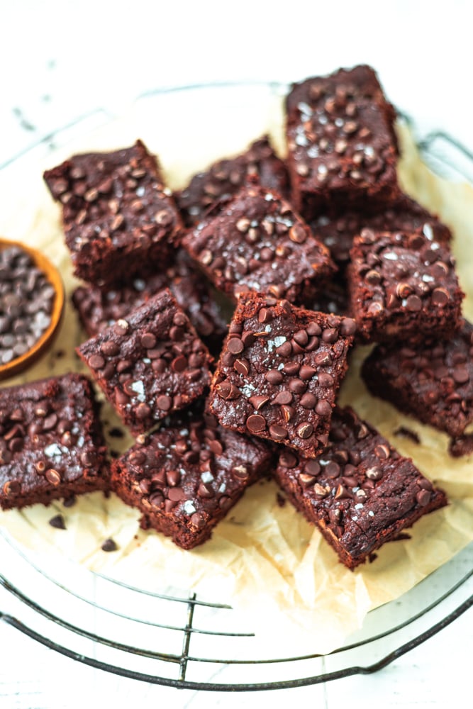deliciously chocolatey lactation brownies cut into squares on a cooling rack with parchment paper.