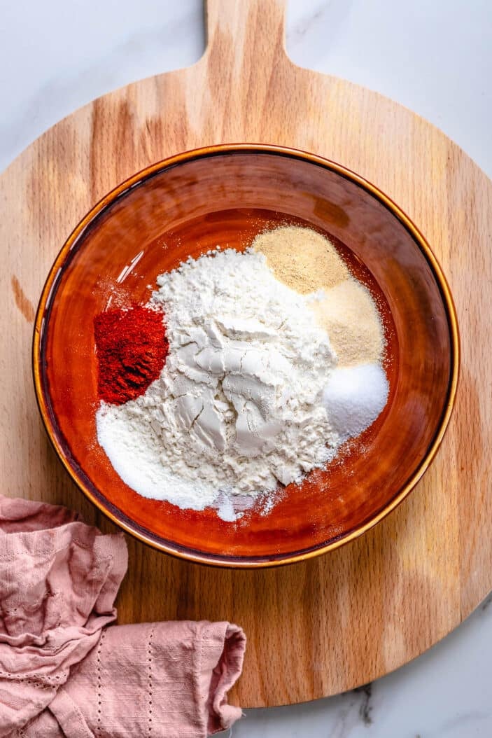 A wide brimmed bowl with the batter ingredients placed inside.
