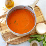 homemade marinara sauce recipe in a saucepan on a cutting board