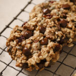 breakfast oat cookies on a wire rack with a pink background