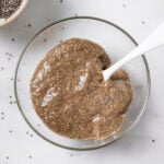 chia seed egg in a clear glass bowl with a spoon in the middle