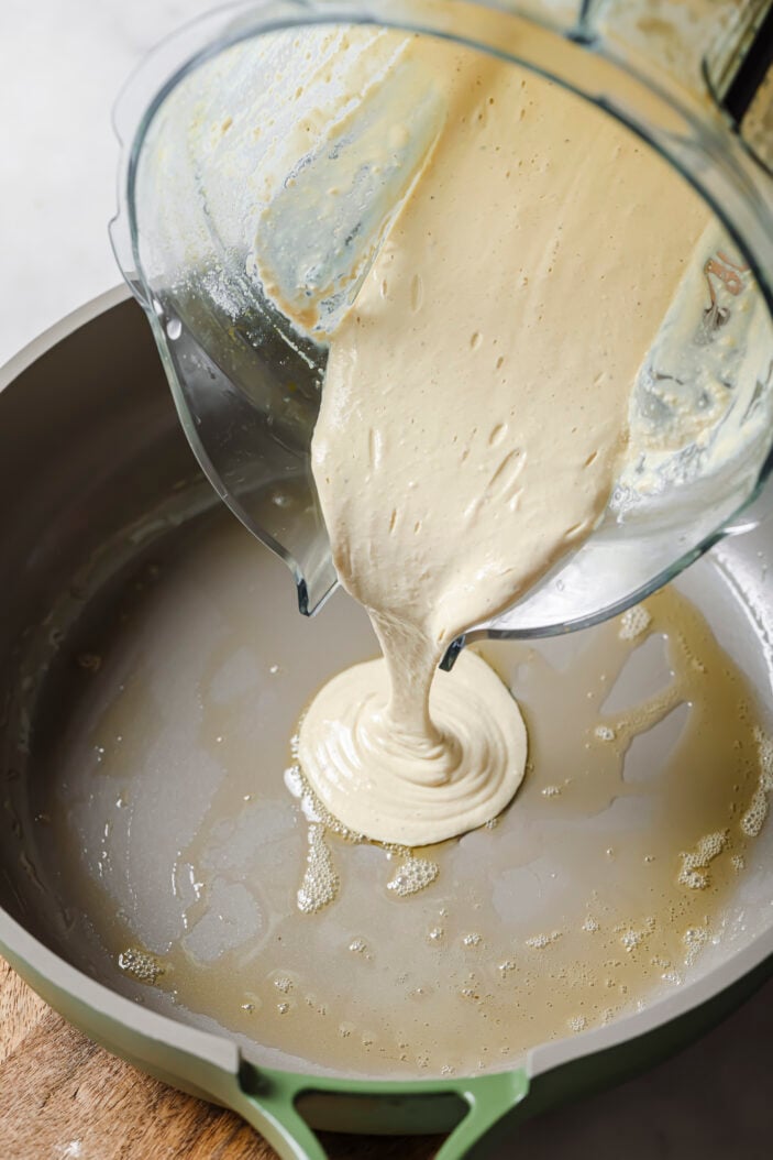 Blended tofu mixture being poured into a oil prepared pan.