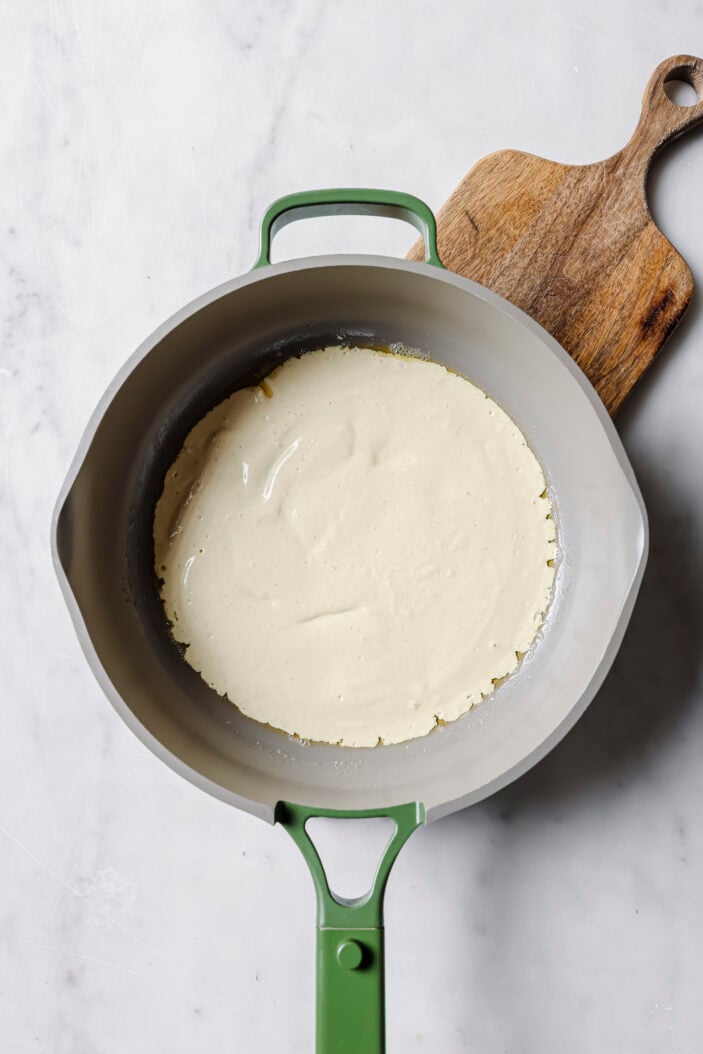 tofu ometllte being cooked in a skillet