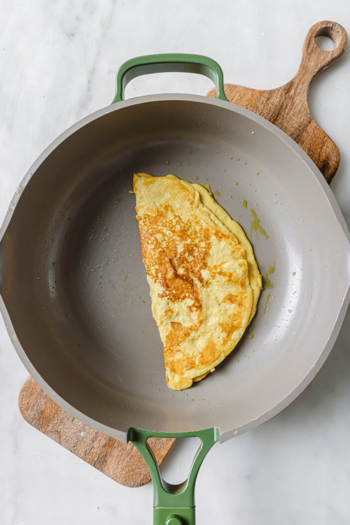 tofu omelette in a skillet that's been folded in half.