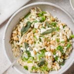 Tangy and herby lemon orzo pasta salad with asparagus and chickpeas. Topped with fried sage and pine nuts.